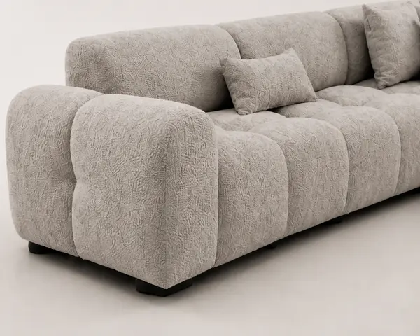 Close-up of bubble tufting texture on light gray sofa