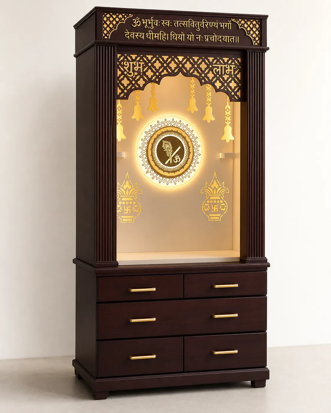Dark walnut mandir unit with gold Om medallion, hanging temple bells and deep drawers.