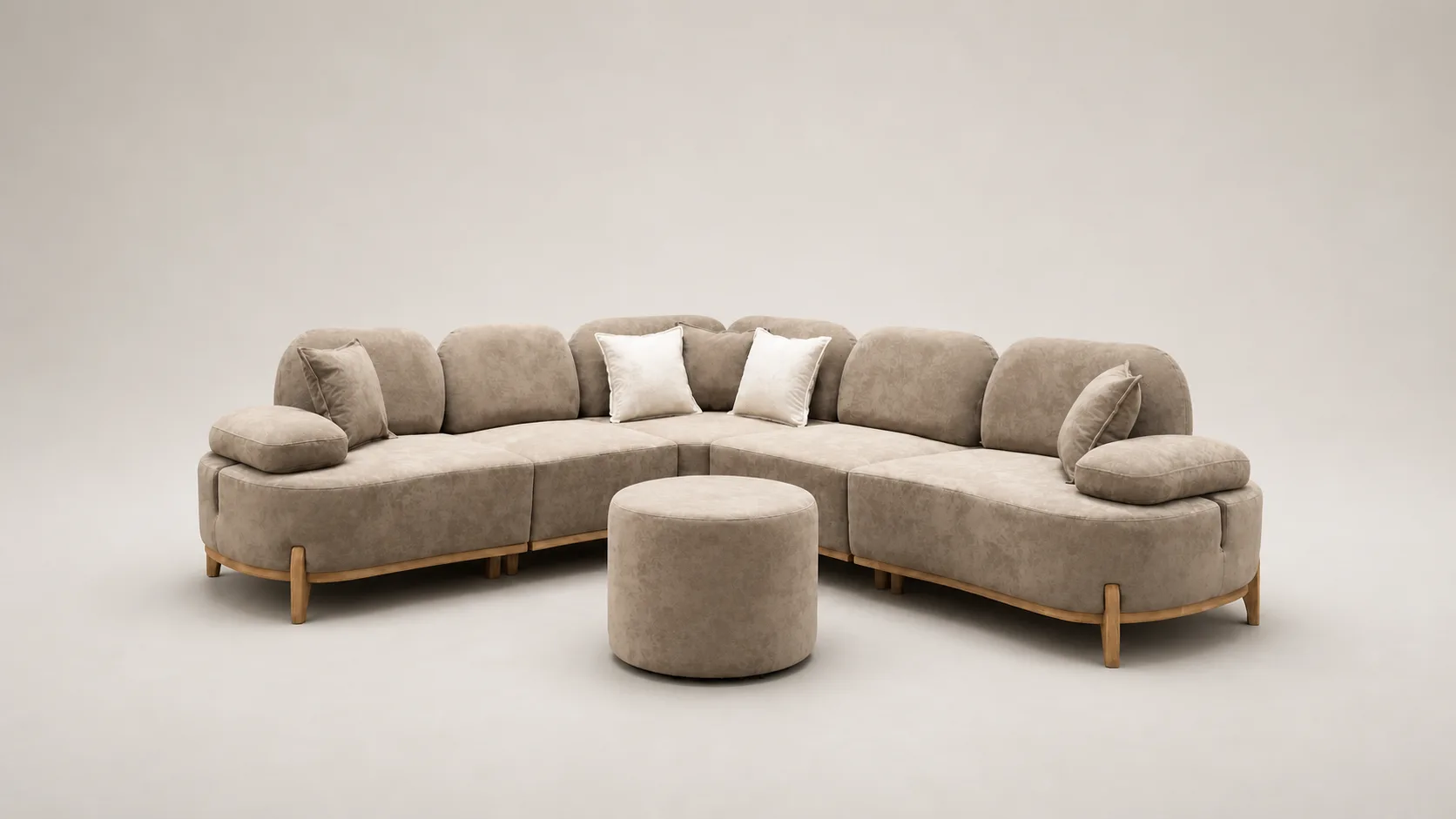 Beige curved sectional sofa with rounded silhouette and round ottoman.