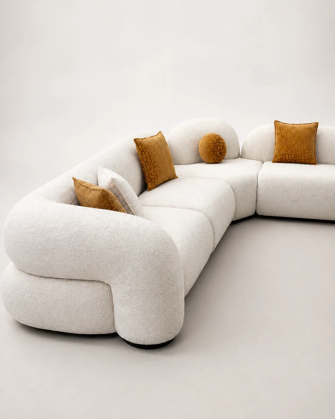 Off-white boucle curved sectional in a styled living room