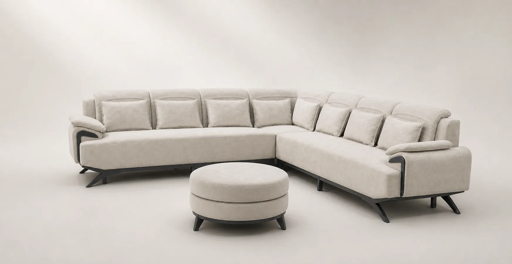 Cream channel-tufted U-shaped sectional sofa with round ottoman.