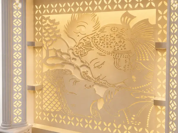 Close-up of the backlit Radha-Krishna jaali panel and fretwork frieze