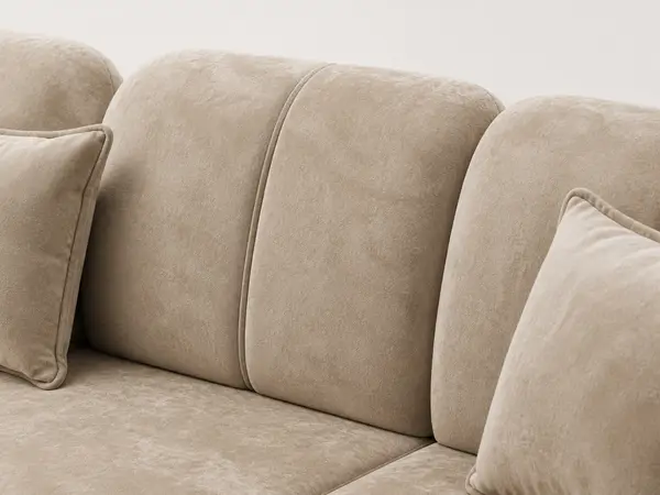 Close-up of channel tufting on tan sectional backrest