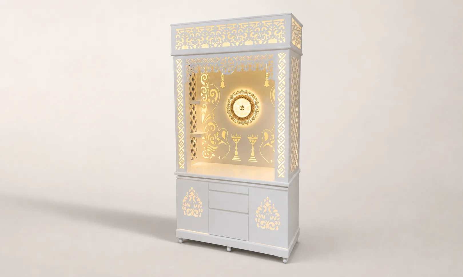 Tall white mandir unit with scrollwork pediment, backlit Om wheel medallion and carved jaali side panels.