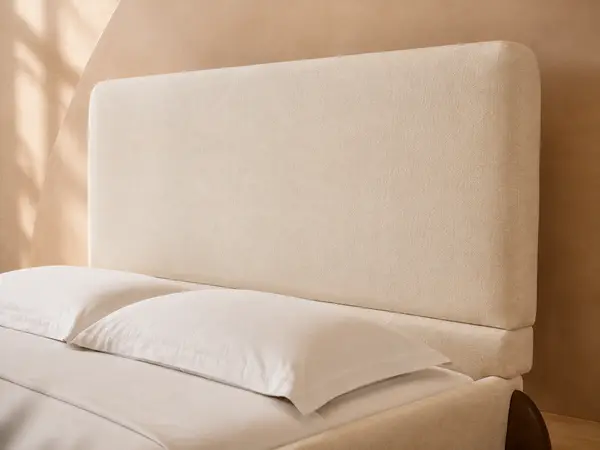 Cream Upholstered Bed with Sculpted Walnut-Tone Feet — detail view 1