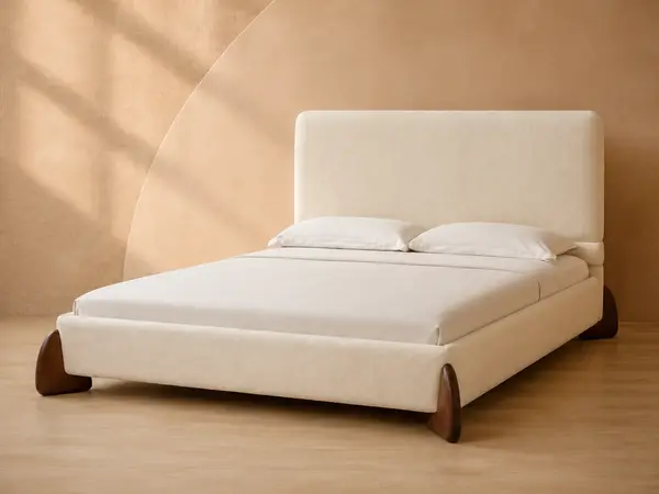 Cream Upholstered Bed with Sculpted Walnut-Tone Feet — angled view