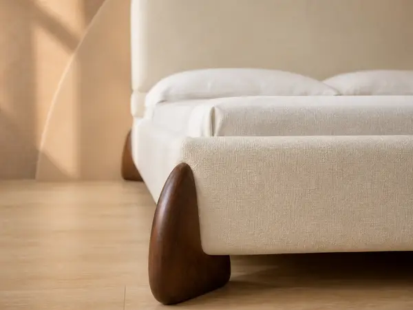 Cream Upholstered Bed with Sculpted Walnut-Tone Feet — detail view 2